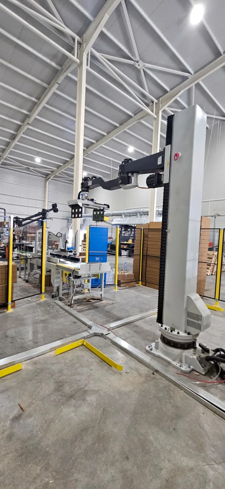 Robotic arm packaging edgebanding rolls at the Burgas facility