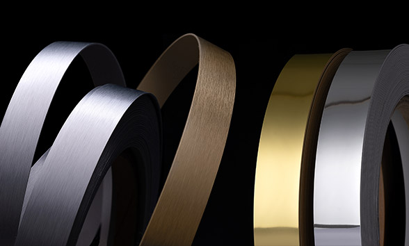 Brushed aluminum and mirror edgebanding rolls in gold, silver, and bronze